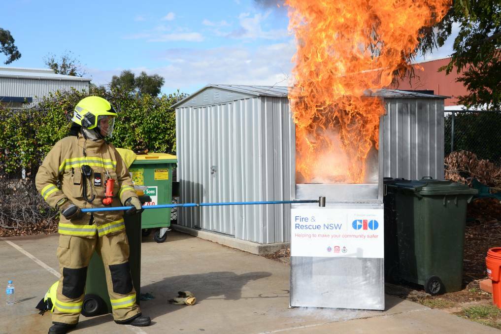 IMPORTANT MESSAGE: Firefighter Charles Antonivich demonstrates the dangers of kitchen fires at last year's open day.