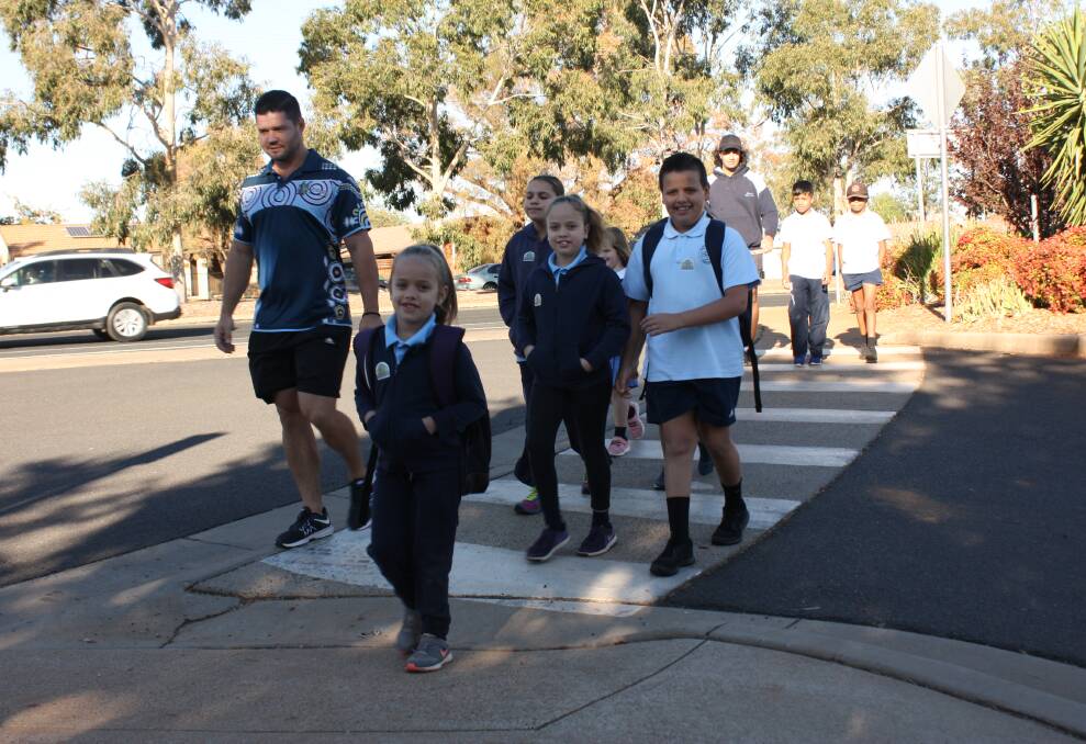 Great initiative: Buninyong Public School  Student Learning Support Officer’s Alex Richardson-Bell and Andrew Taylor with students from The Walking Bus program. Photo: Taylor Jurd. 