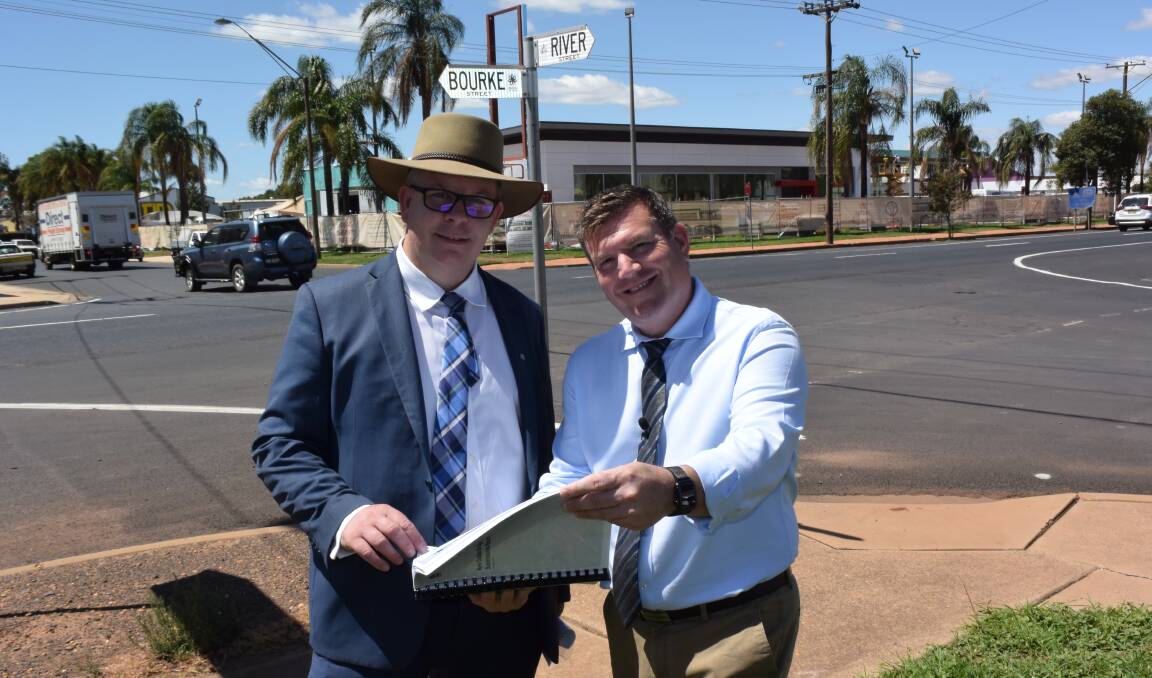 Milestone: Transport for NSW acting western director Alistair Lunn and Dubbo MP Dugald Saunders along the route of the planned River Street bridge with the submissions report. Photo: FAYE WHEELER