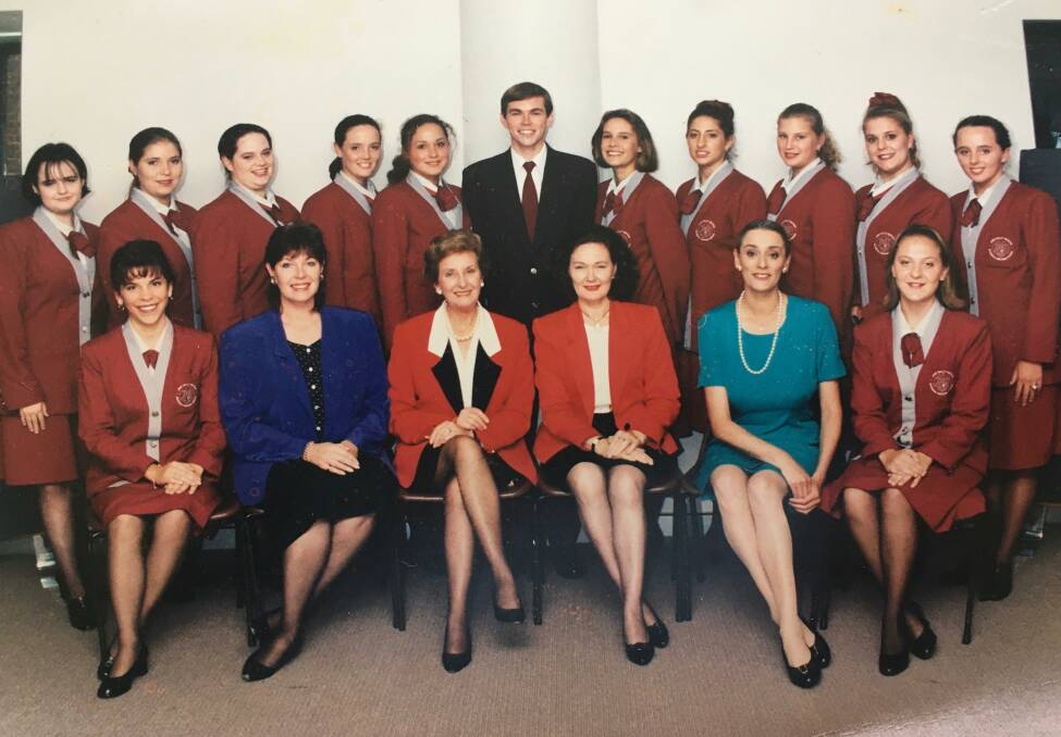Wonderful time: Renai Ransom, nee Hood, (back row, second left) and classmates from the June Dally-Watkins Business Finishing School, with school founder June Dally-Watkins (front row, third left). Photo contributed.