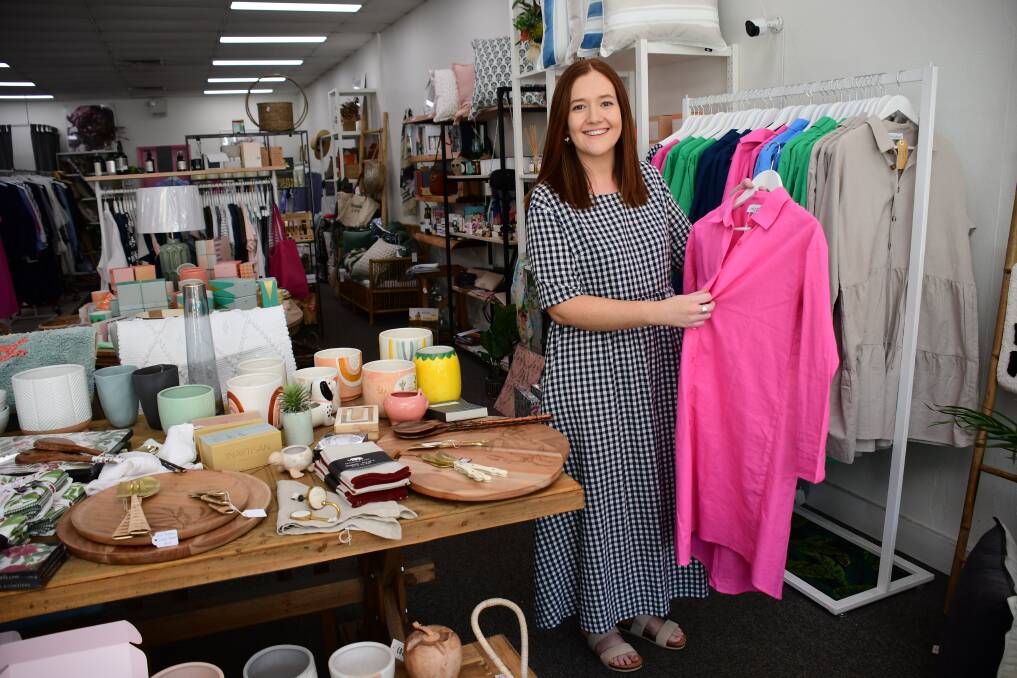 Passion project: Lazy Sunday Lifestyle owner Kate Griffiths wearing a Clementine dress and holding a Poppy shirt dress from 'Wildflower', her first clothing collection. Photo: BELINDA SOOLE