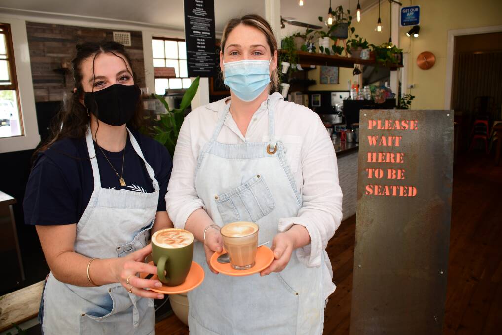 Counting down: Short Street Store team members Maya Piras and Taylor Hallinan prepare for the cafe's first dine-in patrons in weeks when the city comes out of lockdown, likely to be next week. Photo: AMY MCINTYRE