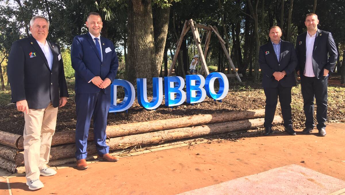 Dubbo Regional Council CEO Michael McMahon, Mayor Ben Shields and councillors Greg Mohr and Dayne Gumley with the sign for Dubbo Road. Photo contributed.