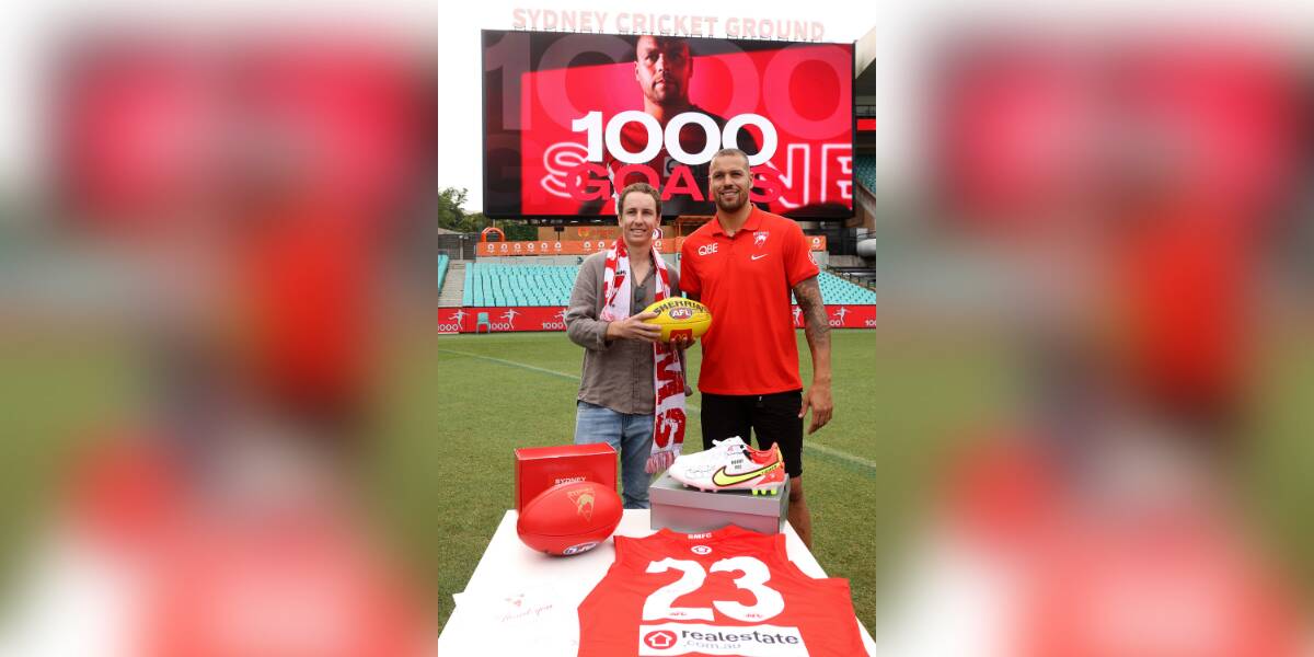 Sydney Swans fan Alex Wheeler meets Lance 'Buddy' Franklin at the SCG to return the ball the giant of the game booted for his 1000th goal on Friday night. Pictures: Phil Hillyard