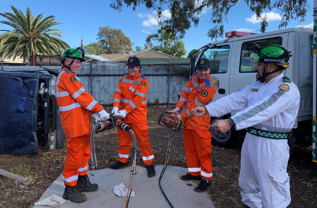 Heavy Lifting: Cadet SES students learn how to carry and operate spreader and cutter devices in the event of an emergency. Photo: NSW SES. 