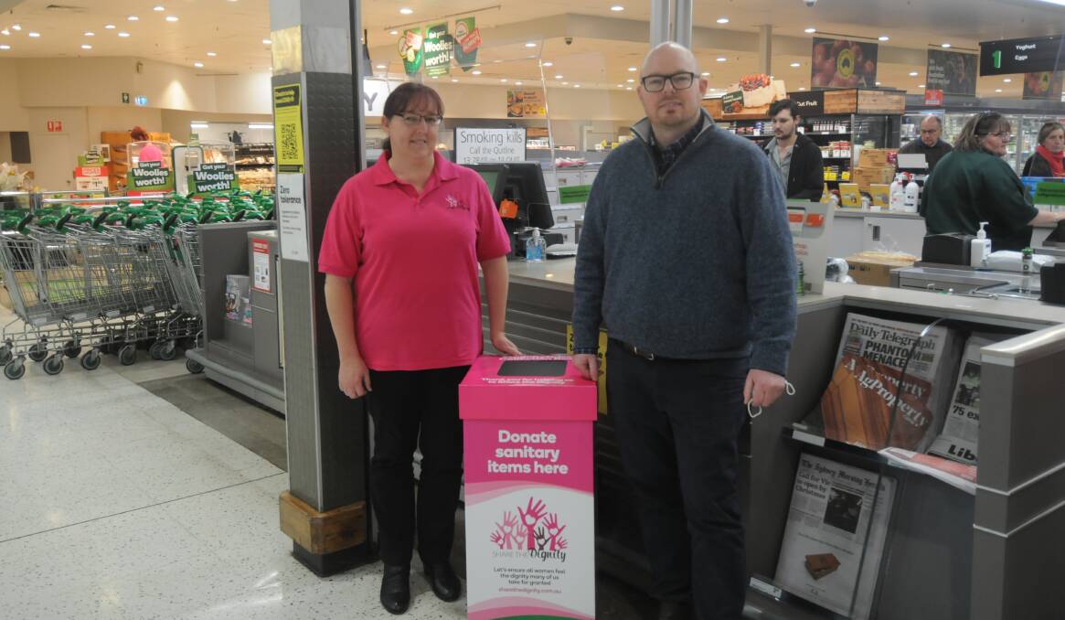 Share the Dignity organiser Lisa Catelotti and Woolworths manager Ben Richards beside the store's collection point. 