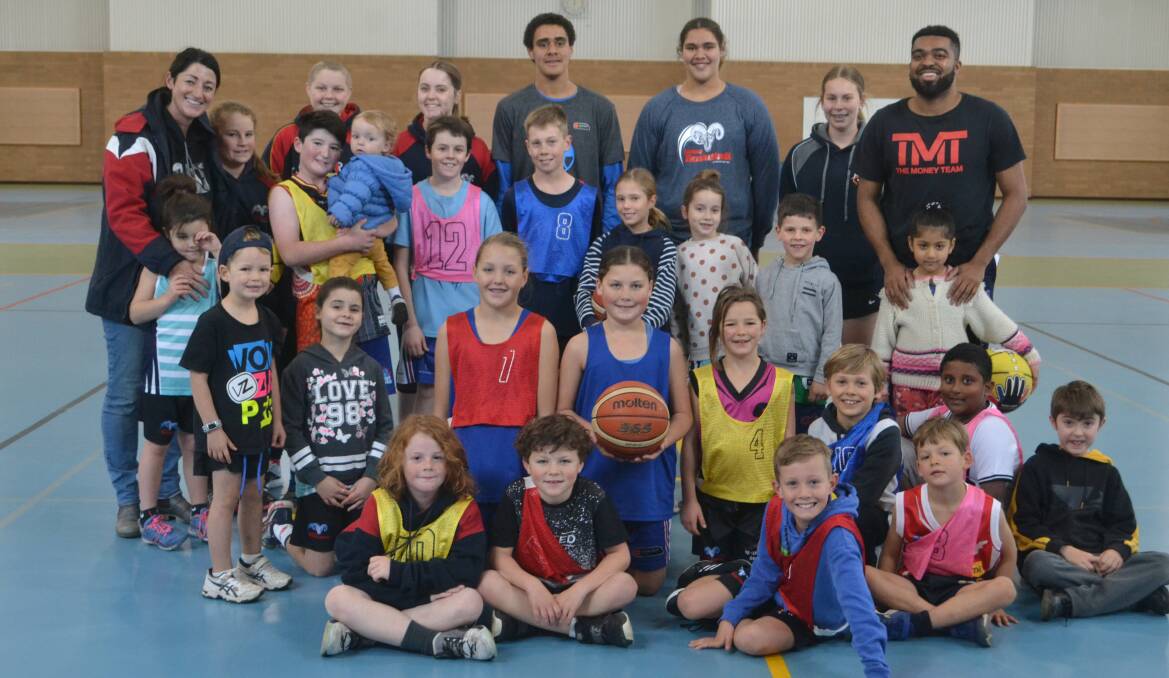 Skills: American import Charles Baines (back right) and other members of the Dubbo Rams alongside their students. Photo: Daniel Shirkie.