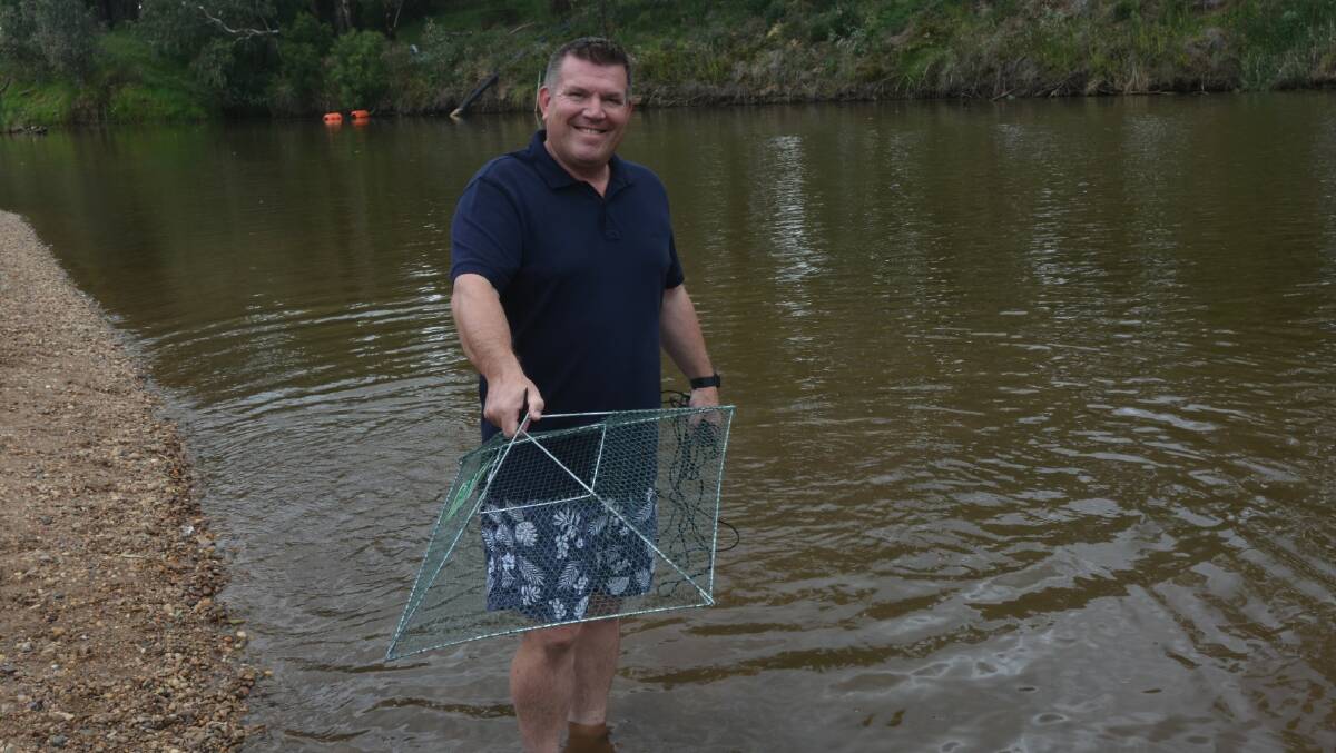 CATCH: Member for Dubbo Dugald Saunders tries out one of the new, free yabby nets that fishers can make use of. Photo: DANIEL SHIRKIE.