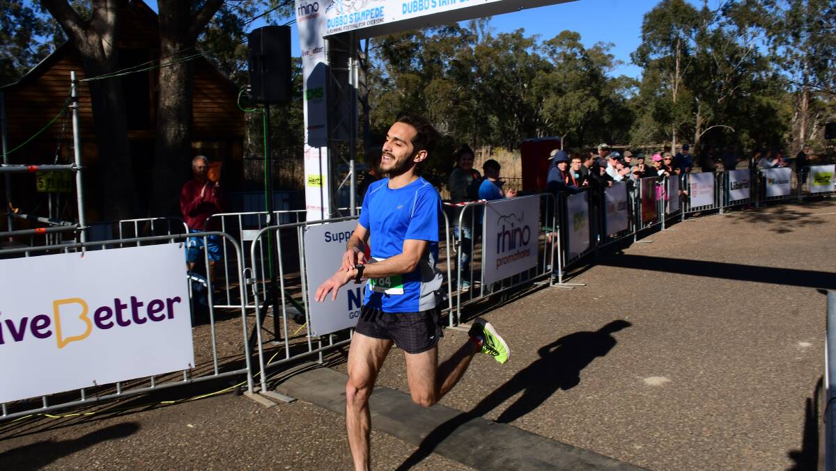 Pumped: A thrilled Daniel Carson crosses the finish line first in the 10km Cheetah Chase. Photo: Amy McIntyre.