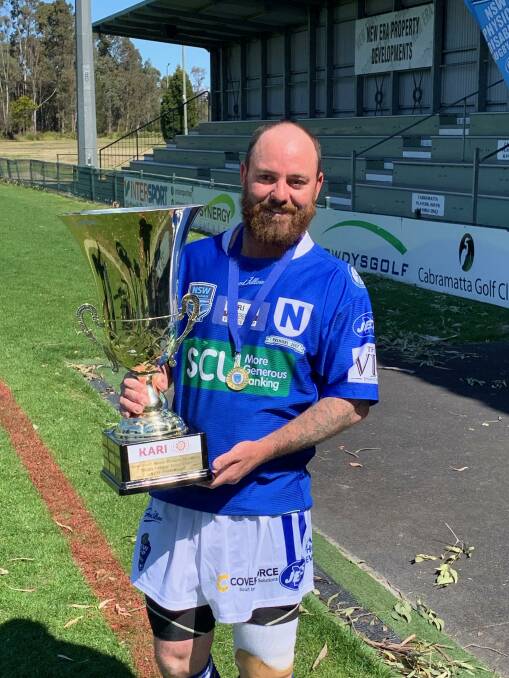 Champion: Brewarrina's Clinton O'Connor holding the premiership trophy won by the Newtown Jets. Photo: Contributed. 
