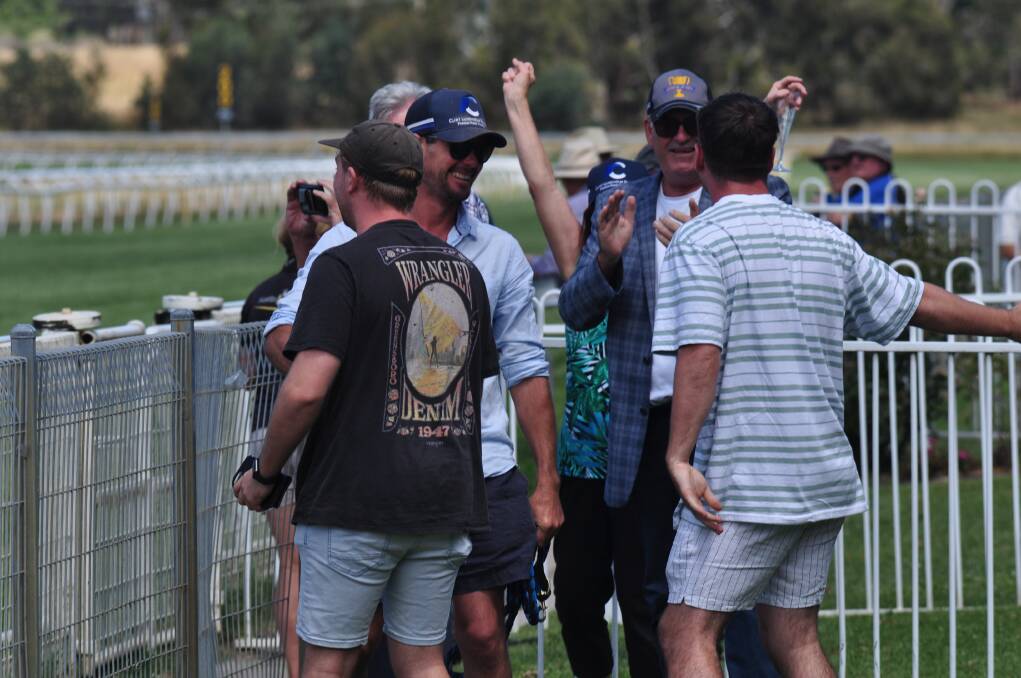 Clint Lundholm celebrates with connections after So Extra's win. Picture by Lachlan Harper 