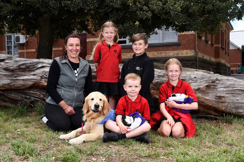 THERAPY: Jacqui MacMillan with dog Honey and Buninyong Primary pupils (back) Ruby, Rylan and (front) Euan with Muffin the guinea pig and Isla with Bluey. Picture: Adam Trafford