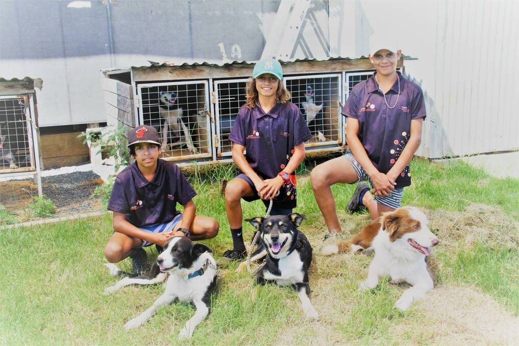 Izzaiah Ebsworth, Hank Hammond and Keith Doolan with some of the dogs from the BackTracks PAWS UP Program. Photo: SUPPLIED