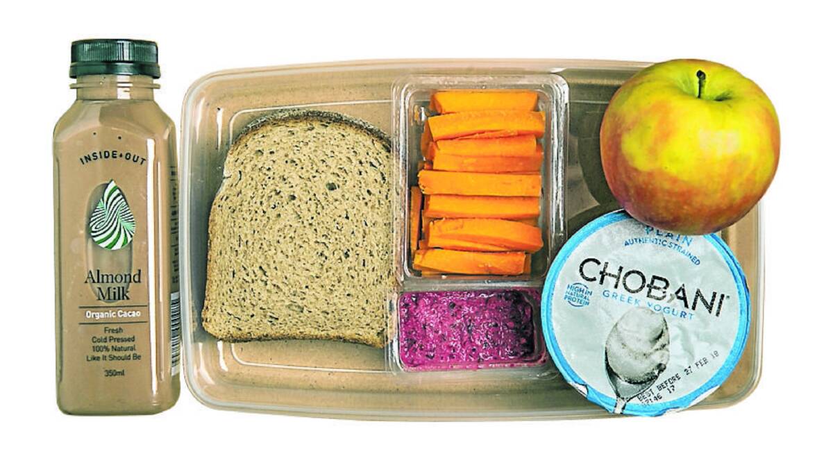 EXAMPLE OF A HEALTHY LUNCHBOX: Wholegrain bread with vegemite, carrot sticks with beetroot dip, plain yoghurt, apple and almond milk = total sugar 28.8 grams. Image: FAIRFAX MEDIA