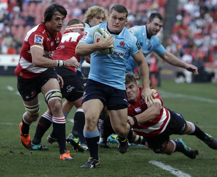 IN THE MIX: Waratahs' Tom Robertson breaks away from the Lions' defenders in last month's Super Rugby semifinal. Photo: AP Photo/Themba Hadebe