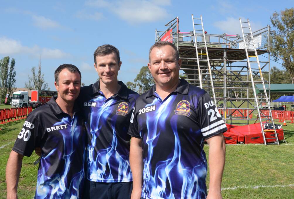 READY: Dubbo's team of Brett Smyth, Ben Moore and Josh Loxley (absent: Scott Drady) help set up for the State Firefighter Championship at Ollie Robbins Oval this week. Photo: JENNIFER HOAR