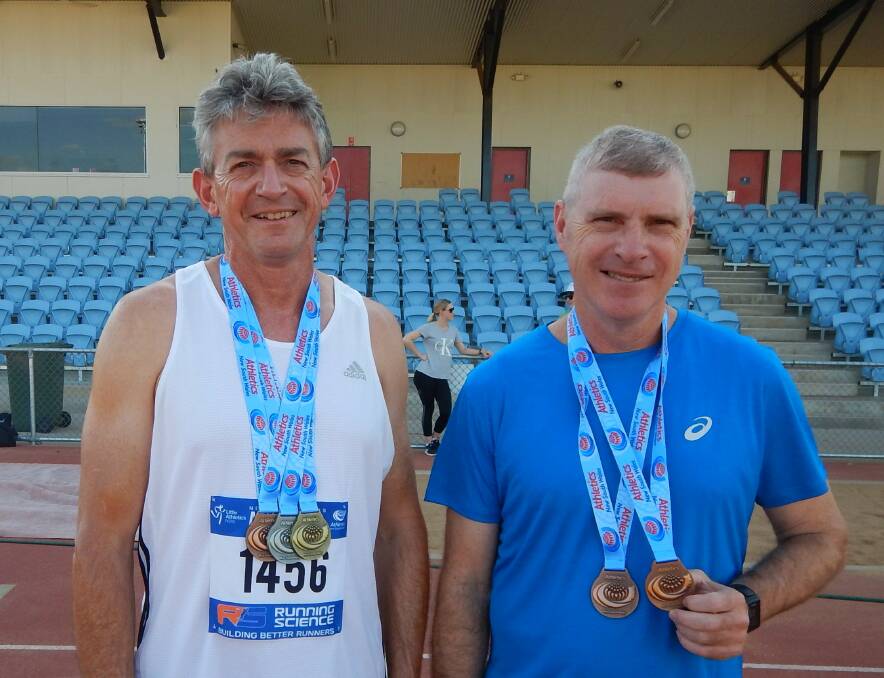 Trevor Kratzmann and Peter Starr with the medals they claimed at the recent NSW Masters Athletics Championships. Photo: SUPPLIED