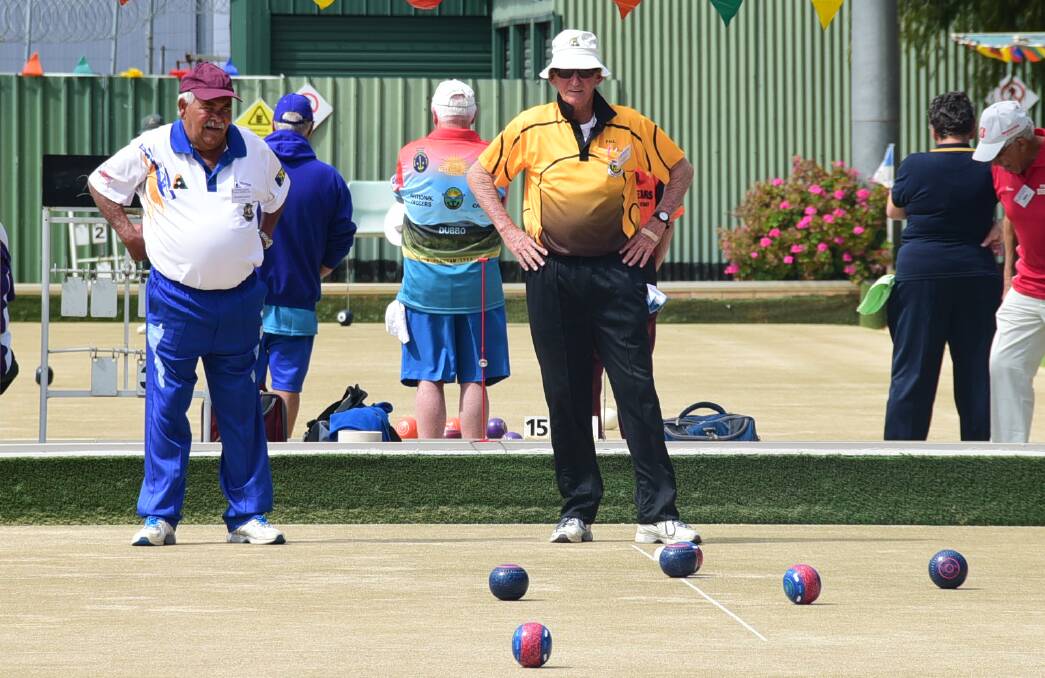 MATESHIP: Tracker Elms, Wellington, and Paul Hutton, Perth, assess the lay of the bowls on the green at Dubbo Railway Bowling Club. Photo: BELINDA SOOLE