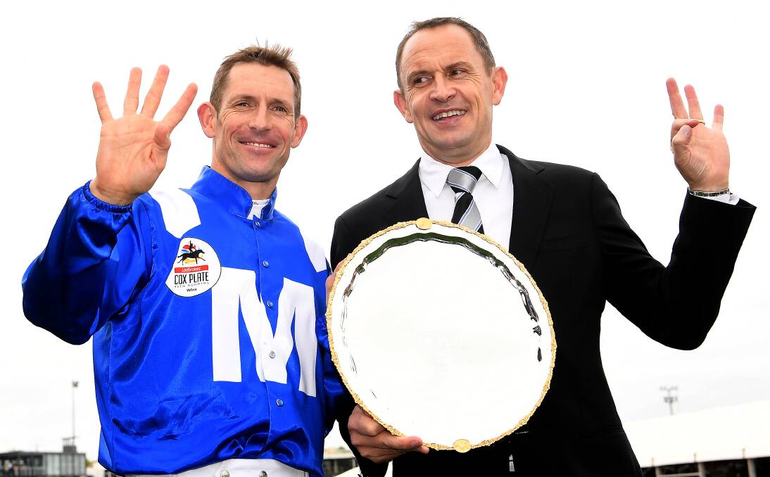 SHE'S APPLES: Hugh Bowman and Chris Waller with the Cox Plate after Bowman rode Winx to her fourth Cox Plate at Moonee Valley Racecourse on Saturday. Photo: AAP Image/Julian Smith