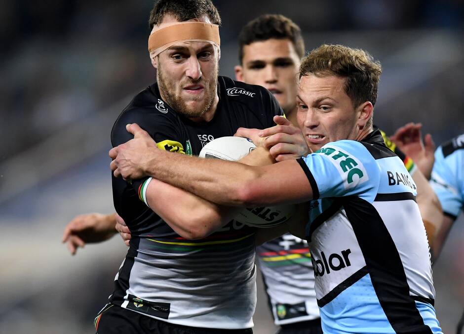Isaah Yeo wrestles with former Panthers teammate Matt Moylan during the 2018 NRL finals series. Photo: AAP Image/Dan Himbrechts

