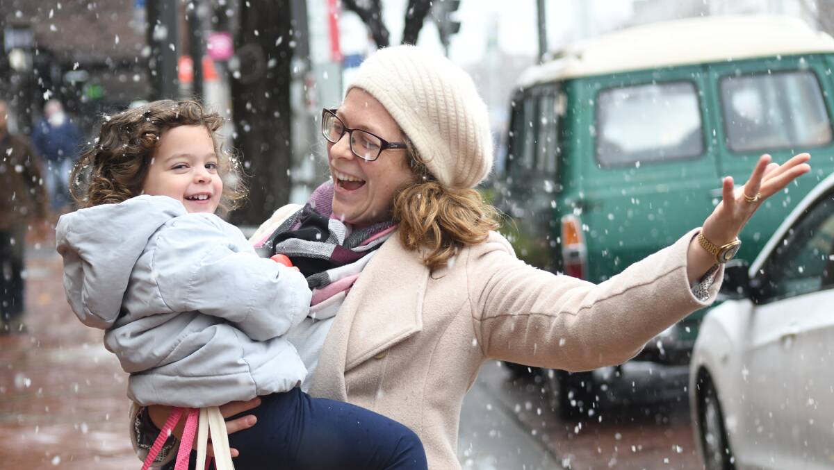 GOOD TIMES: Amelia and Sally Ortega enjoying the first snow of the year. PHOTO: JUDE KEOGH