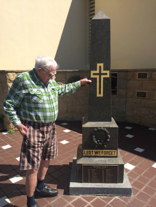 Trevor Brooker reads the names on the war memorial in Dungog.