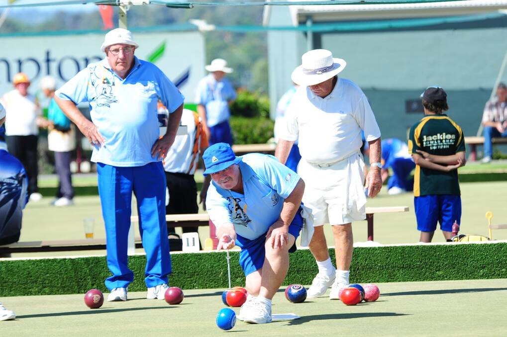Norm Wirth on the mat, while Steve Davis and Kevin Carr look on during the triples tournament at Club Dubbo on Saturday.	Photo: CHERYL BURKE