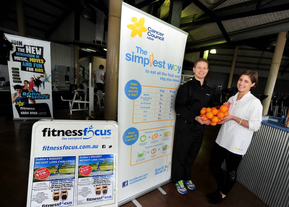 Fitness Focus owner Andrew Bassett and Camilla Barlow from Cancer Council NSW with a bag of healthy oranges. Fitness Focus will host a training day for volunteers to run healthy eating programs at Dubbo schools. 									      Photo: LOUISE DONGES