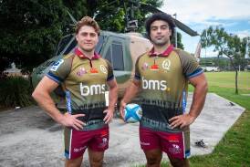 James O'Connor (l) and Zane Nonggorr display the Queensland Reds' Anzac Round jersey. (HANDOUT/QRU)