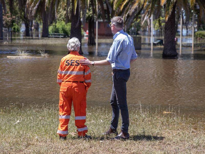 NSW Premier Dominic Perrottet speaks to Susan Bennett of the SES at flood-hit Condobolin last week. (Rebecca Bennett/AAP PHOTOS)