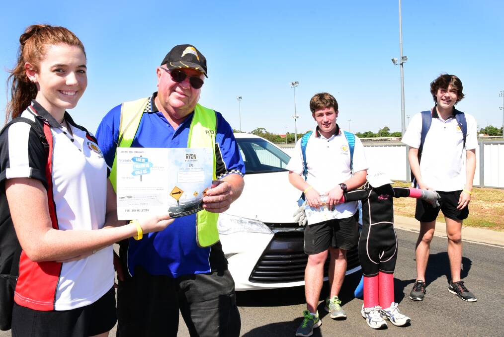Dubbo College Senior Campus students Kendel Sommerville, Euisden Edwards and Joey Matthews take part in a Rotary Youth Driving Awareness program session with driving instructor Greg Reichart. 			    Photo: BELINDA SOOLE