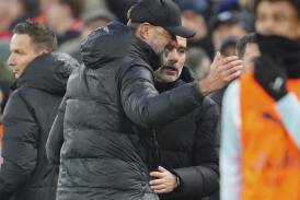 Jurgen Klopp (in the foreground) and Pep Guardiola embraced after their last Premier League draw. (AP PHOTO)