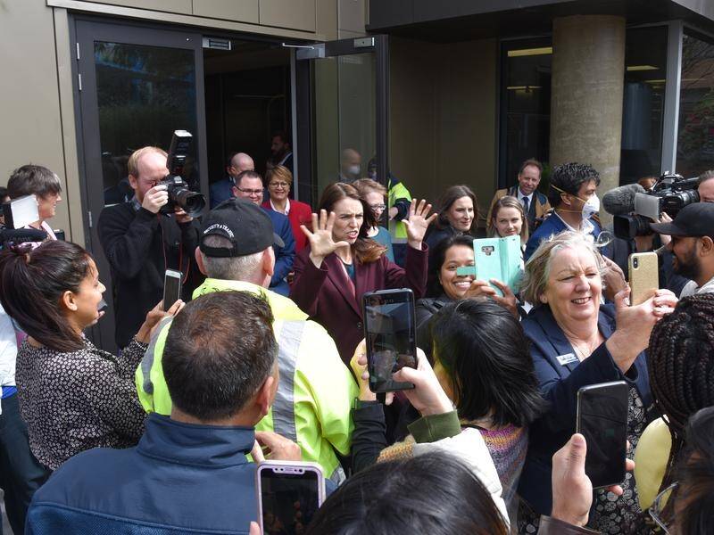 NZ leader Jacinda Ardern took a crowd-pleasing selfie when she was surrounded at Palmerston North.