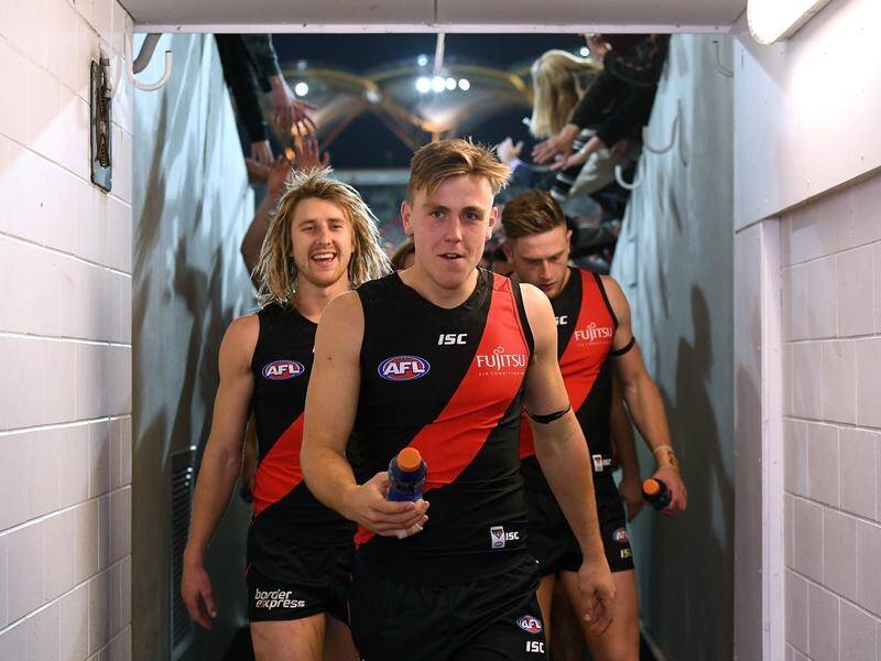 Essendon's Josh Begley (C) is out for the rest of the AFL season with a torn ACL.