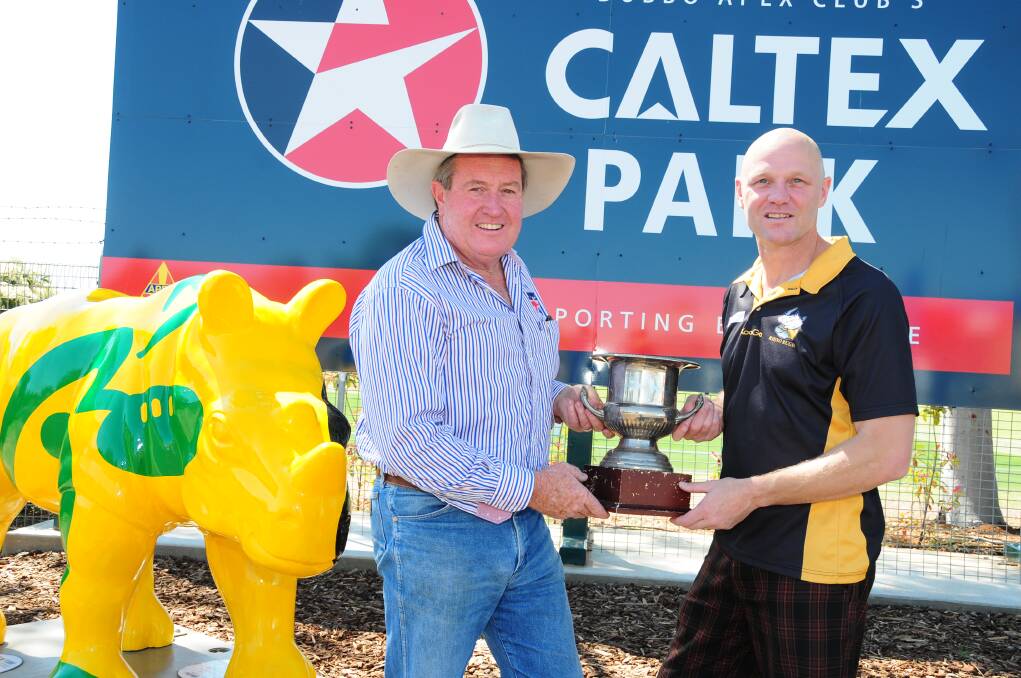Dubbo Kangaroos president Graeme Board with Rhinos counterpart Ian Burns and the Mark Melville Cup prior to a junior match between the two clubs in 2014. 														Photo: BELINDA SOOLE