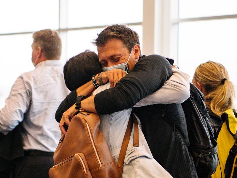 There were hugs, tears and smiles at Adelaide Airport after border restrictions were lifted.