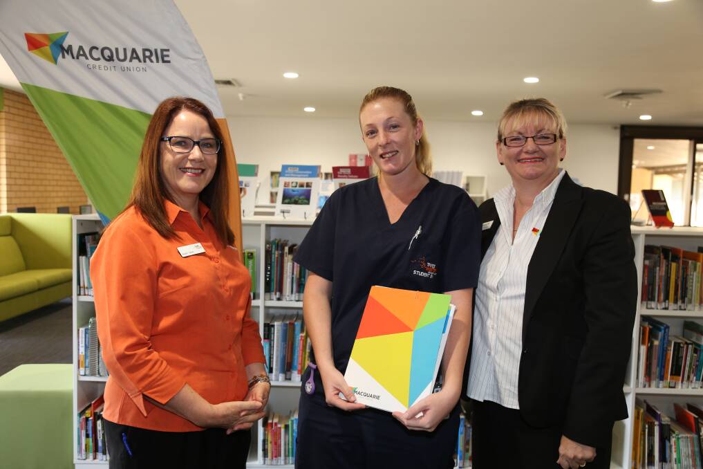 TAFE Western Institute relieving director Susan Carey (left) and Macquarie Credit Union deputy general manager Leanne Bourne (right) congratulate Krystal Brassington on receiving a $1000 scholarship.							      Photo: Contributed