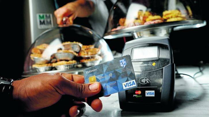 Future of Finance: A customer pays by Visa payWave. Contactless payment systems have become popular in an increasingly cashless society. 