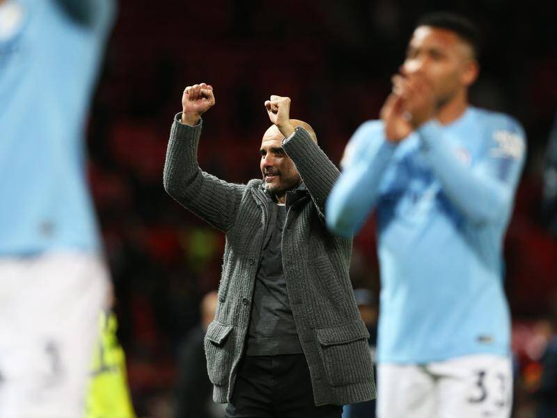 Manchester City manager Pep Guardiola (C) celebrates his team's EPL win at Manchester United.