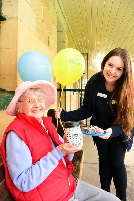 Dubbo cancer survivor Flo Ashby is served morning tea by Cancer Council NSW events co-ordinator Brianna Carracher at the public launch of Australia's Biggest Morning Tea in Dubbo. 			   Photo: BELINDA SOOLE