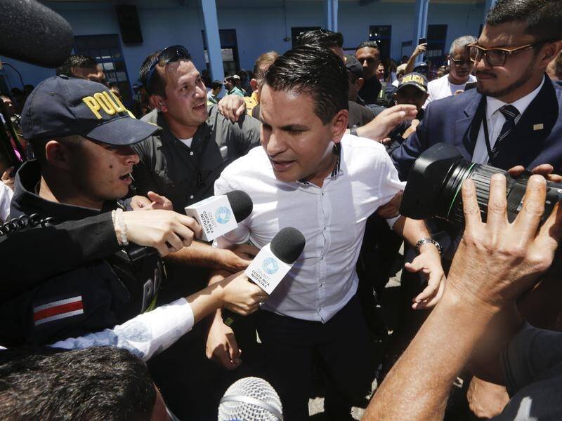 Presidential candidate Fabricio Alvarado talks to the press after casting his vote on Easter Sunday.
