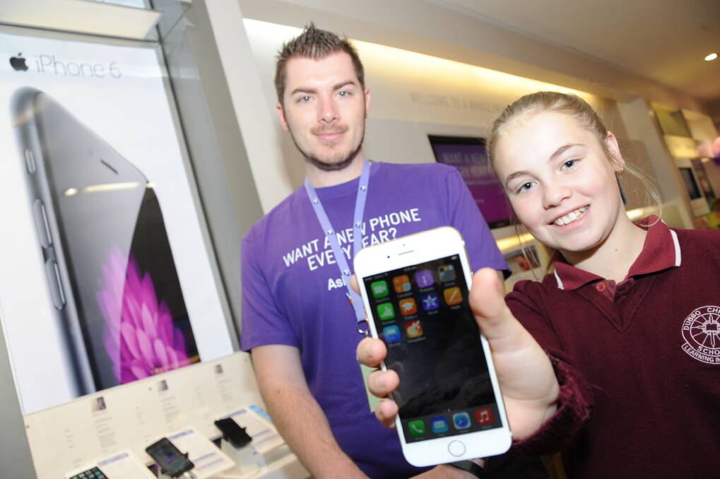 Telstra Shop store manager Dane Stevenson with Courtney Moult, the proud owner of a brand new iPhone 6.	Photo: BELINDA SOOLE