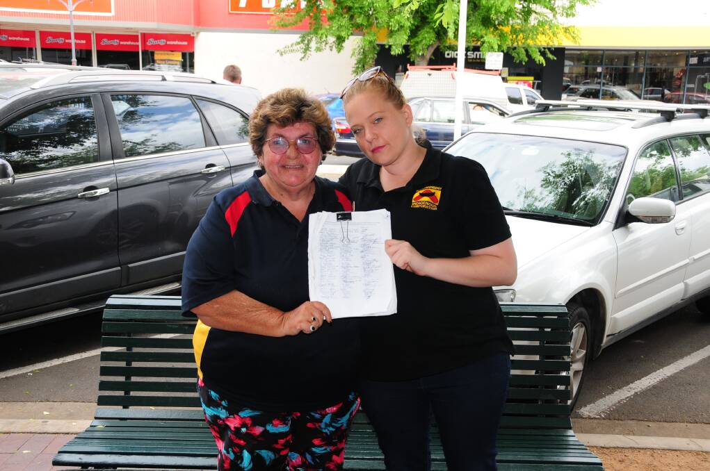 Nguumambiny Indigenous Corporation CEO manager Lynn Field and volunteer Tahni Waters show off the signatures they have received so far.  
Photo: CHARLIE WHITELEY