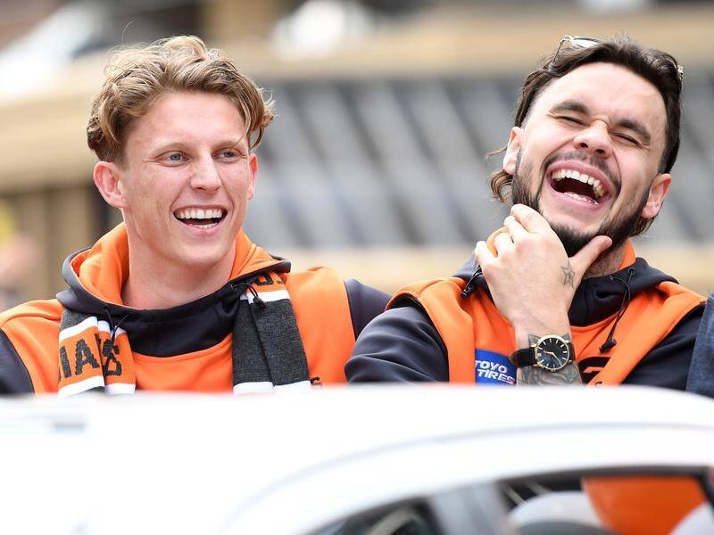 GWS say Zac Williams (r) seen with Lachie Whitfield (l) is happy at the club and will sign again.