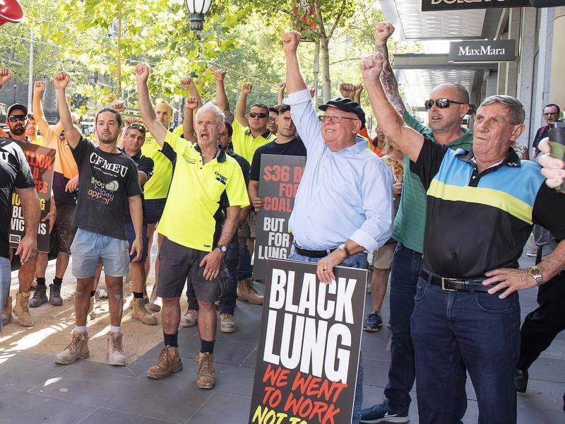 Coalmine dust disease victims and their supporters protest outside BHP's Melbourne office on Friday.