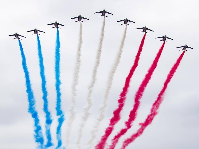 Jets fly over the Arc de Triomphe during the Bastille Day military parade in Paris