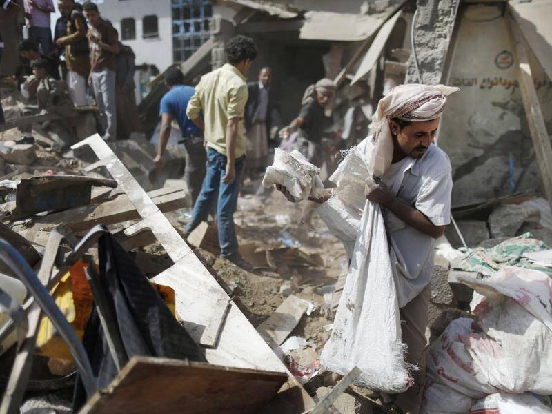 A vendor salvages goods after a blast in the Yemeni city of Aden (file photo).