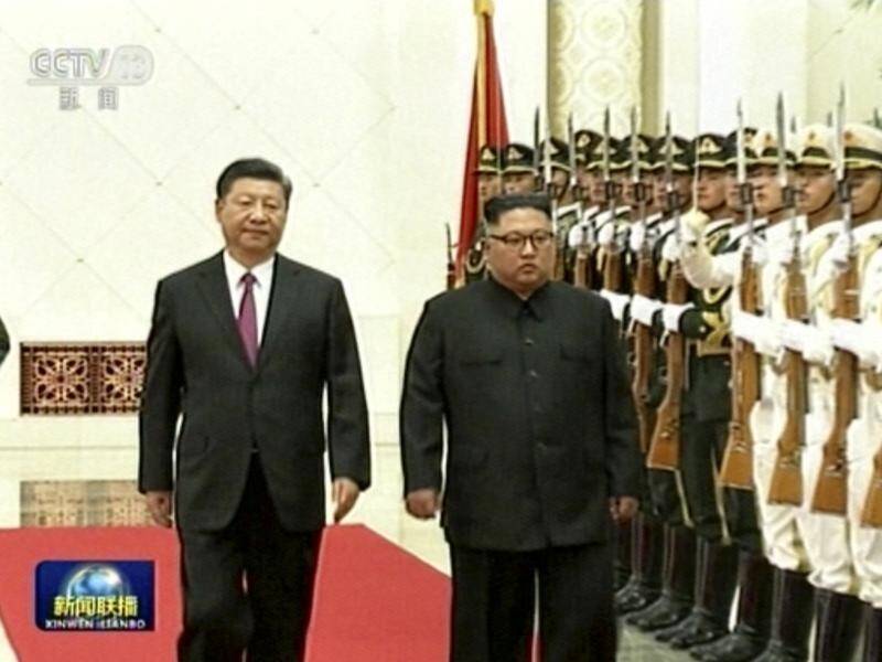 China Central Television has shown Chinese President Xi Jinping welcoming Kim Jong-un in Beijing.