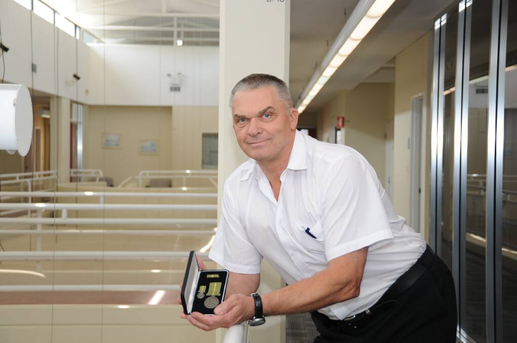 Ingo Steppat with the Humanitarian Overseas Service Medal that he received for his work in Samoa during the 2009 tsunami.  
Photo: BELINDA SOOLE