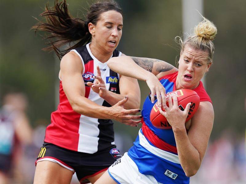 Hannah Scott (r) has no intention of softening her aggressive approach for AFLW's Bulldogs.